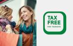 Dwie uśmiechnięte kobiety z torbami na zakupy w rękach. Po prawej stronie napis: TAX FREE FOR TOURISTS